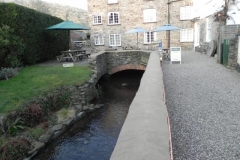 29. Emerges from beneath Town Mill